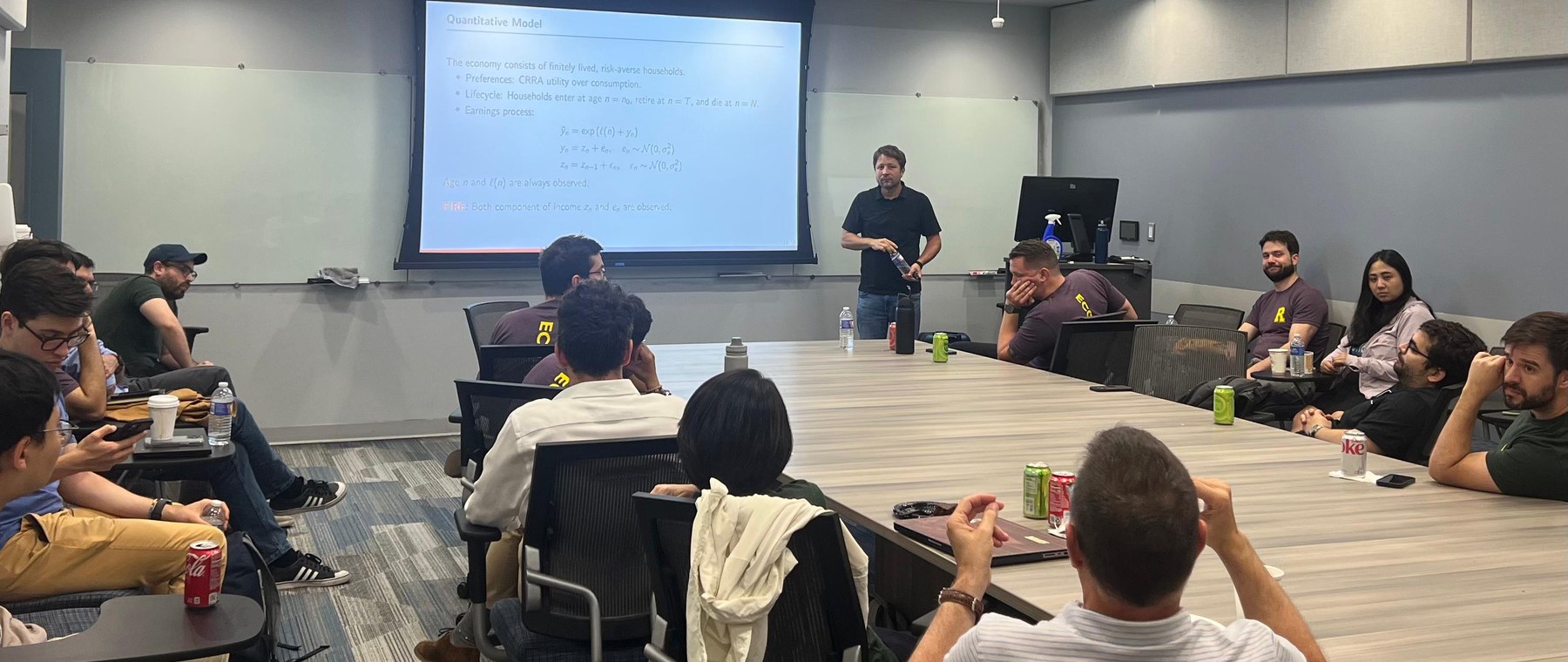 Juan M. Sánchez presenting quantitative macroeconomics research